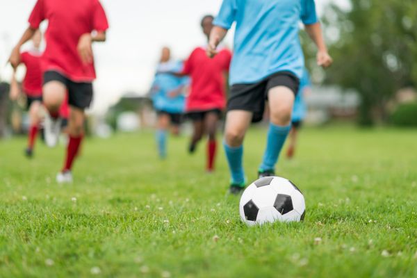 Asyiknya bermain sepak bola bersama teman